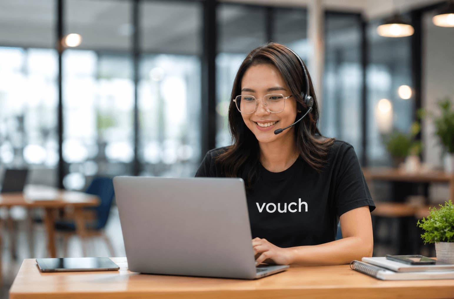 Vouch Front Desk Service agent supporting a hotel’s guests remotely by headset and laptop